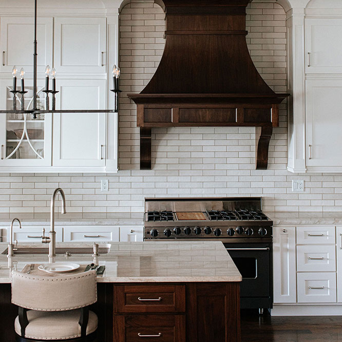 Modern kitchen with a mix of dark and light colors, featuring framed overlay cabinets for a timeless and stylish look. 