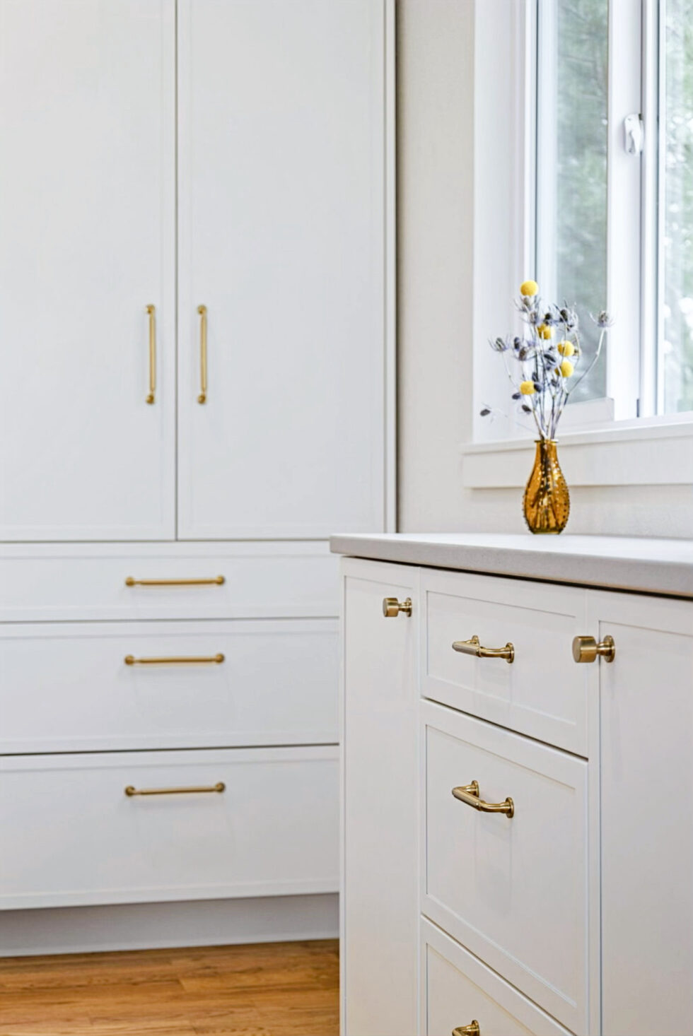 White cabinetry with gold hardware creating a clean and sophisticated look.